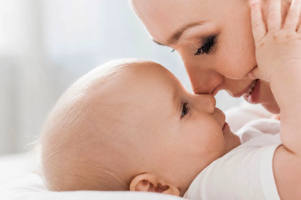 Parent smiling with infant at Katherman Tongue Tie Center