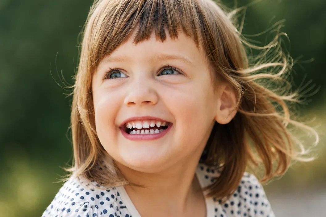 Smiling child after receiving supportive oral care